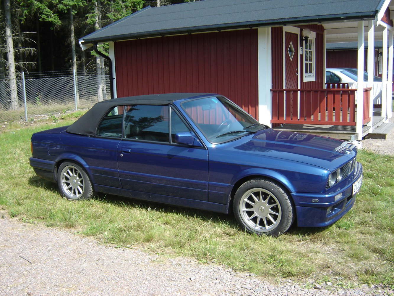 Blue convertible with black soft top and alloy wheels