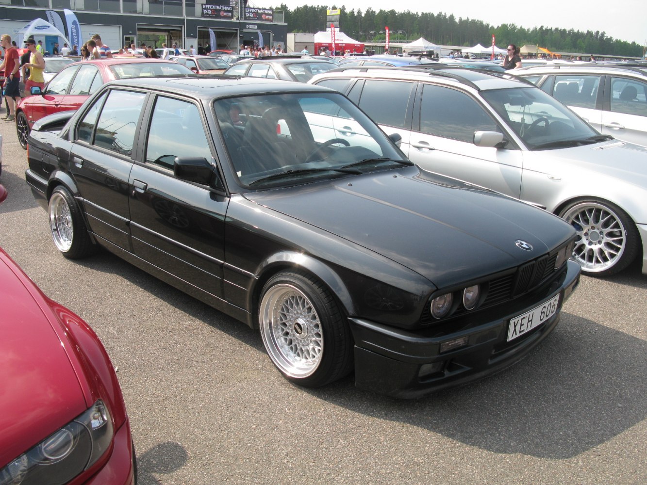 Black sedan with mesh alloy wheels and tinted headlights