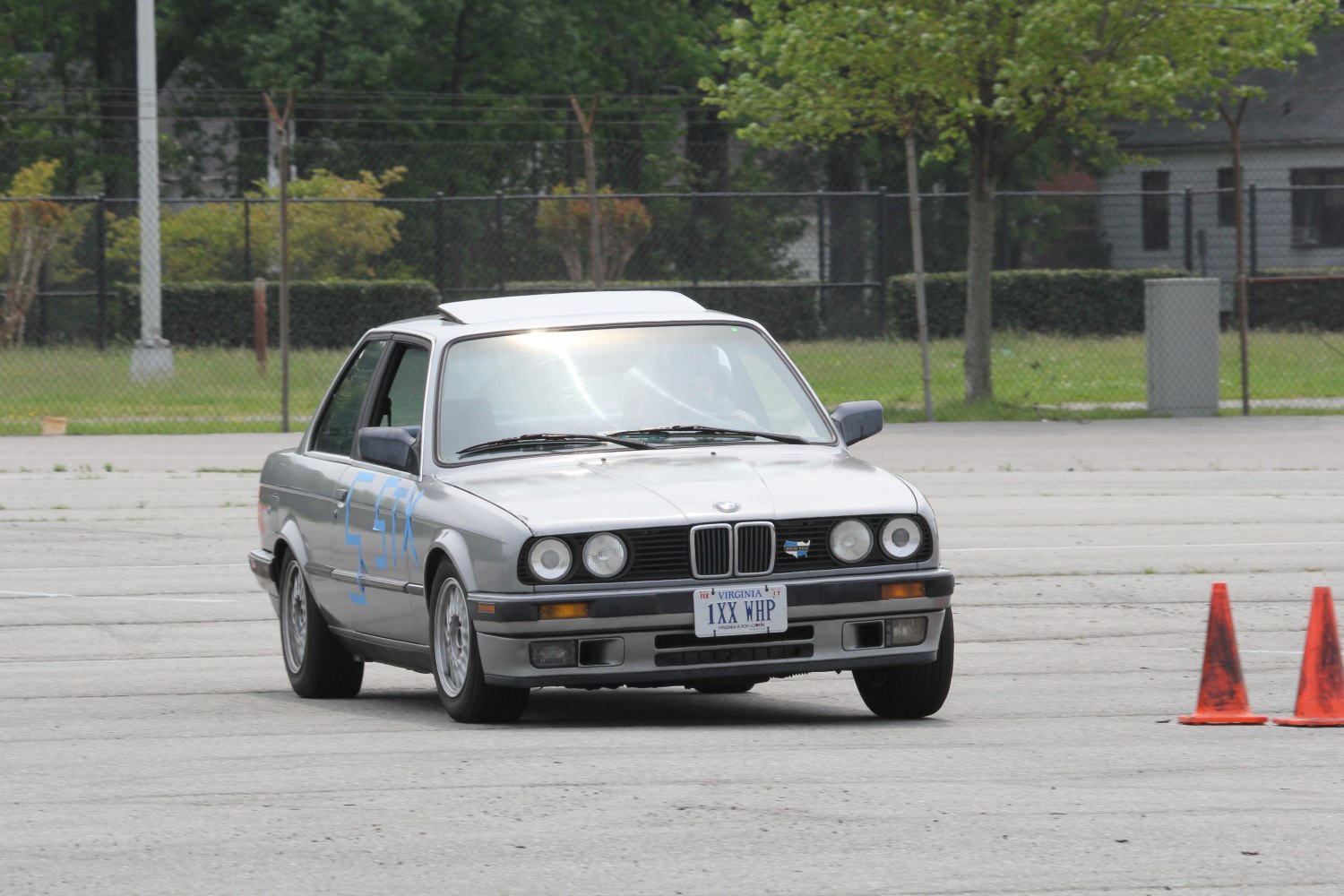 Silver vintage coupe with quad headlights on track