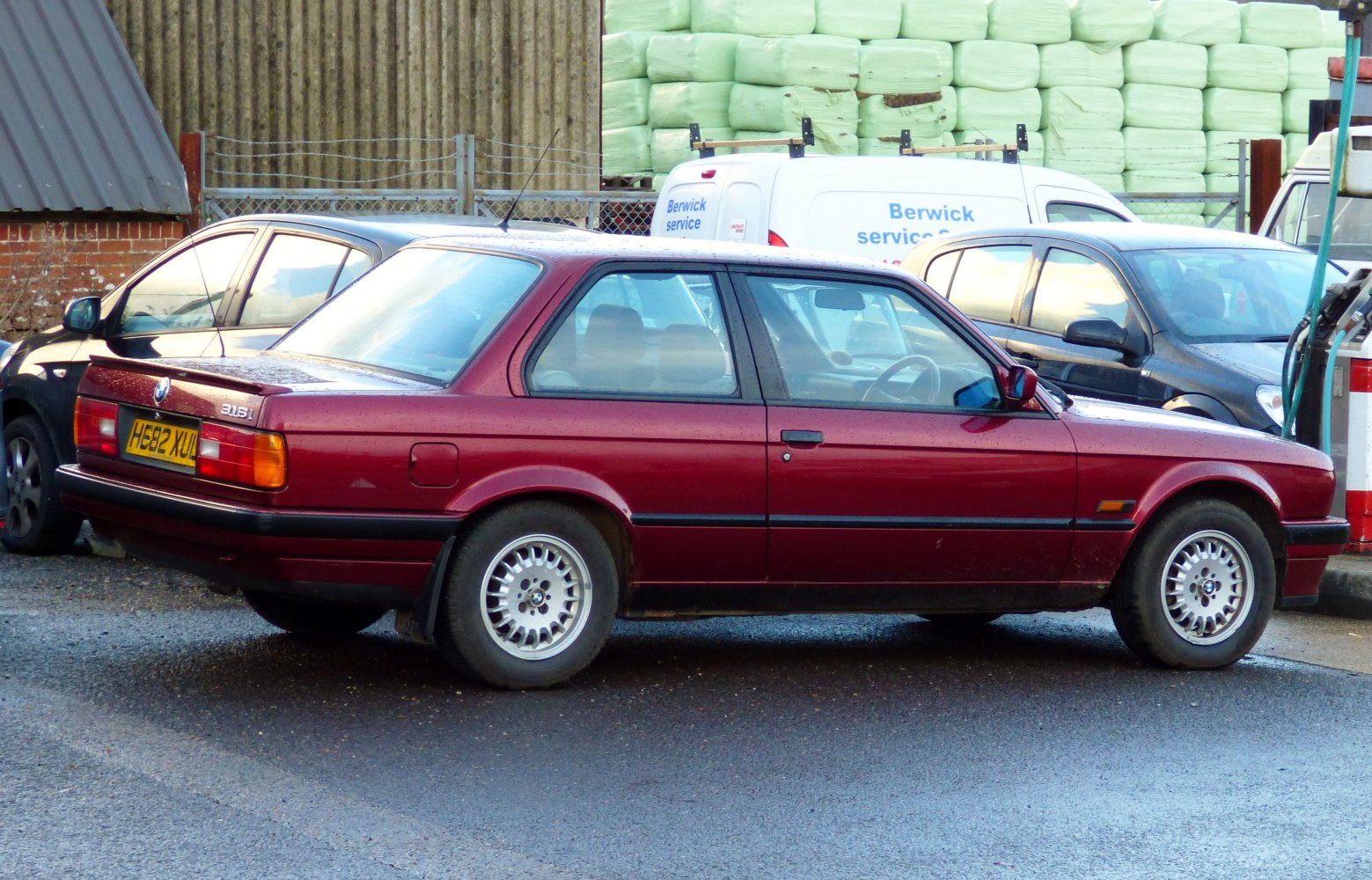 Side profile of a two-door coupe with alloy wheels and classic design lines.