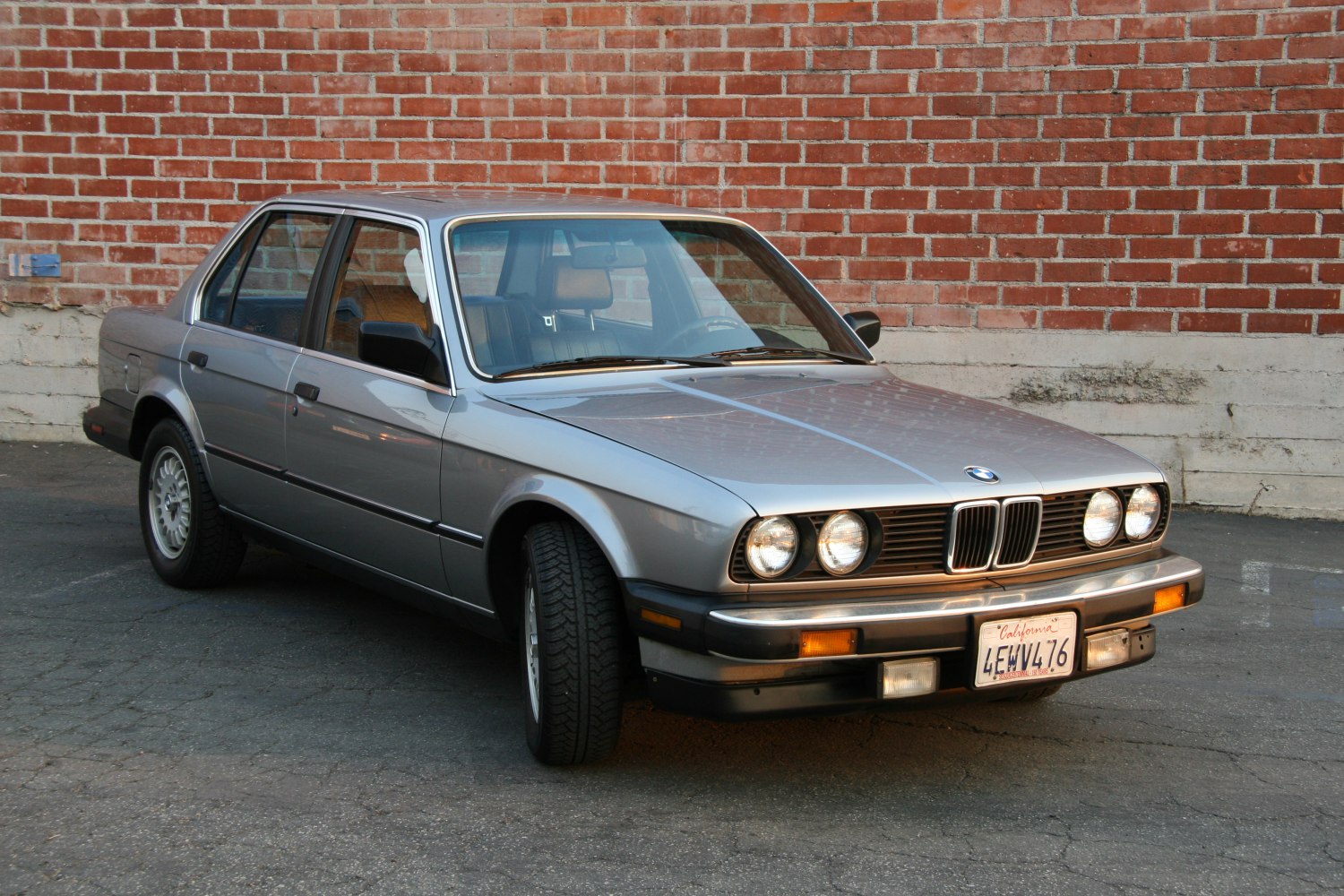 4-door sedan with quad round headlights and chrome detailing