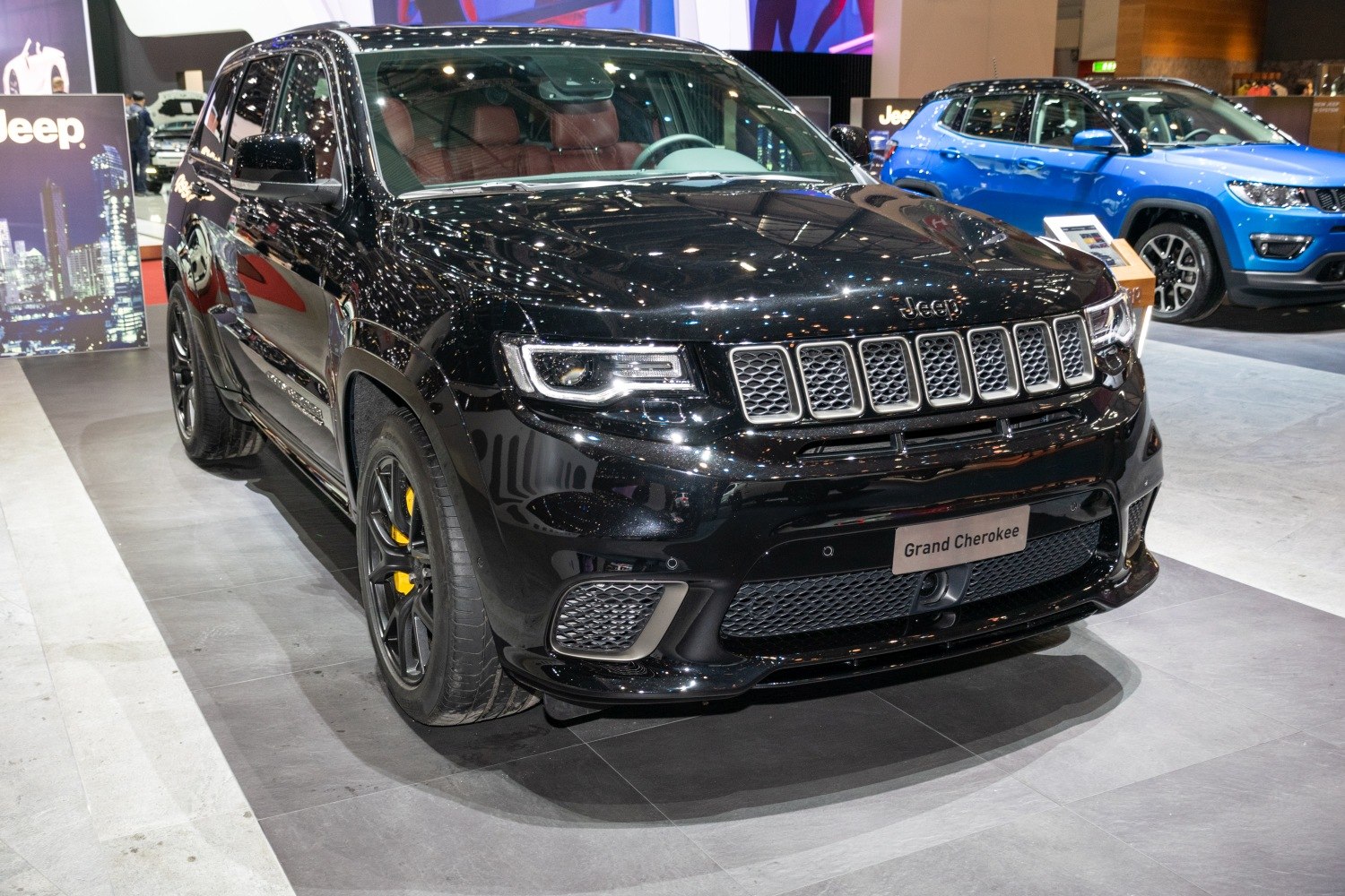 Glossy SUV front with distinctive grille and yellow brake calipers
