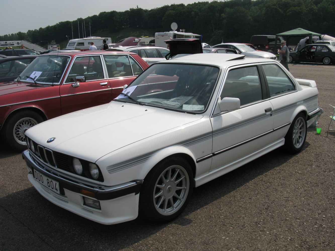 White coupe with alloy wheels and sporty front styling