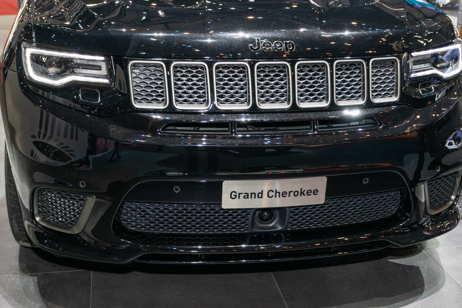 Front grille and LED headlights of a black SUV