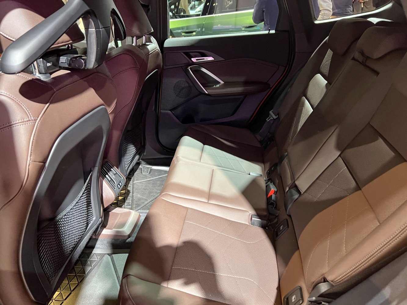 Brown leather rear seats with spacious legroom and modern door panel