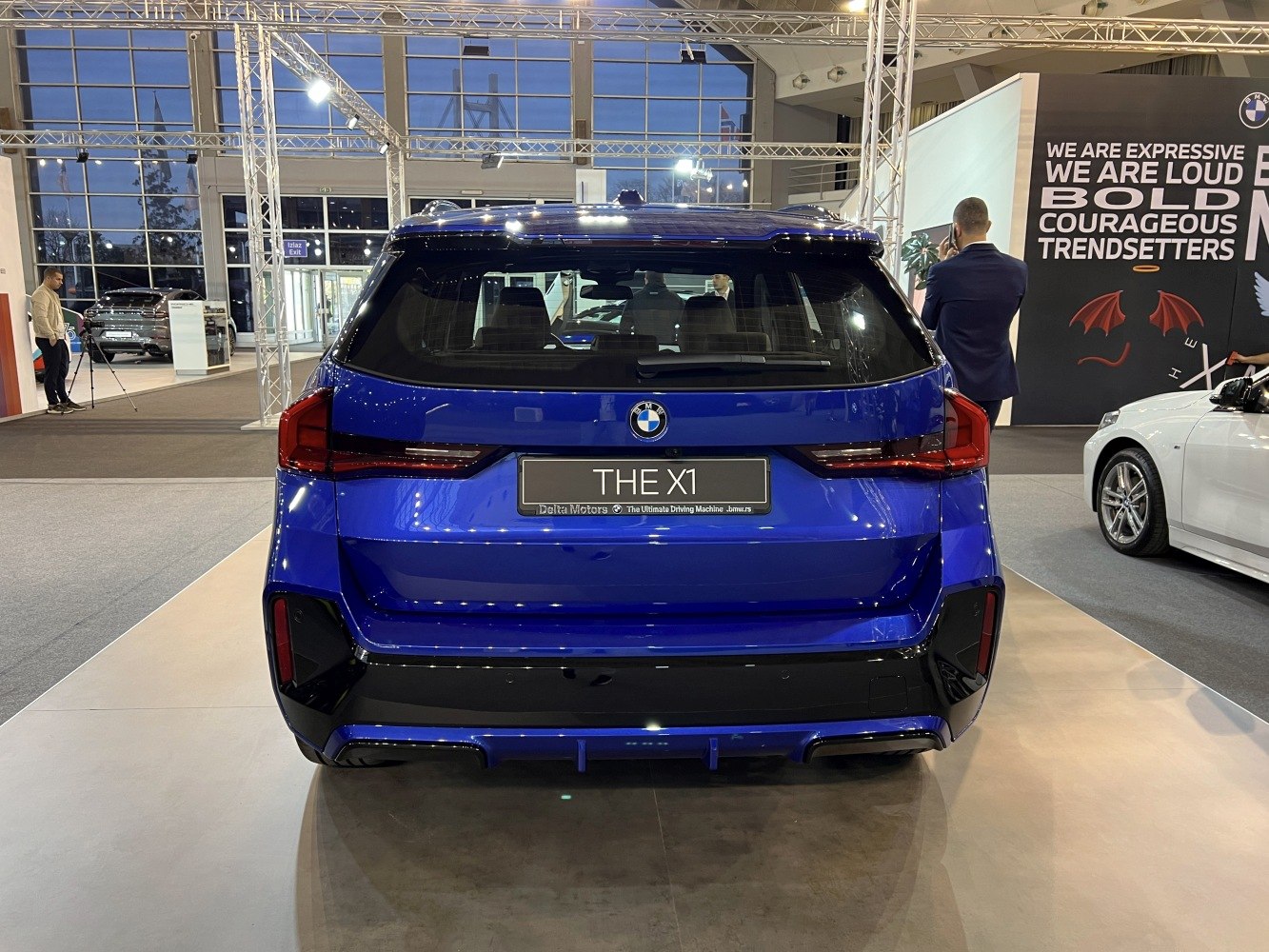 Rear view of a blue SUV with sleek taillights and modern bumper design.
