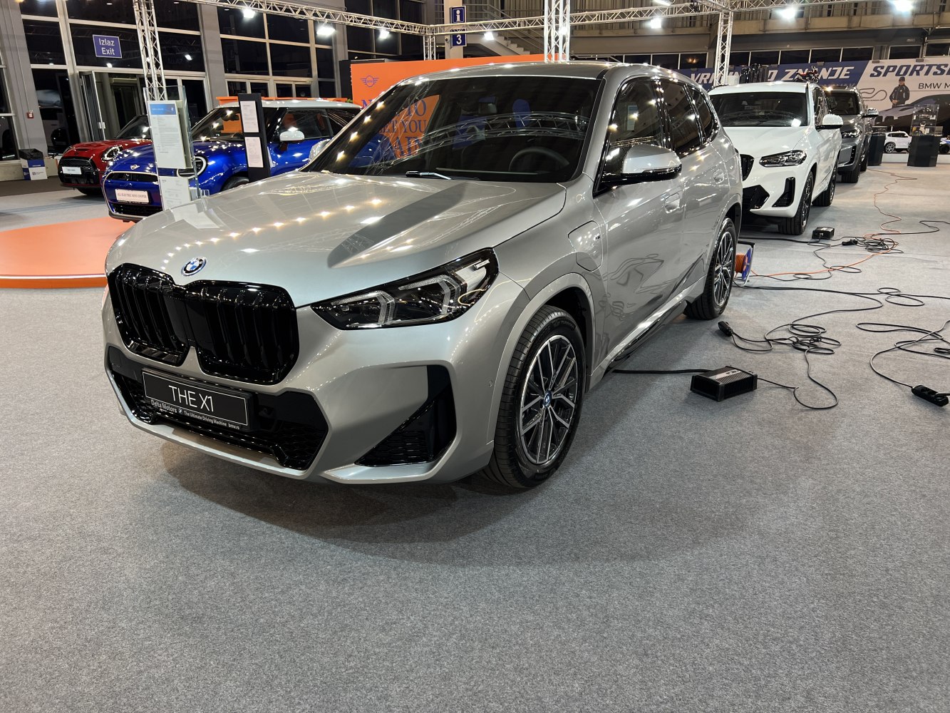 Silver SUV with black kidney grille and sporty alloy wheels.