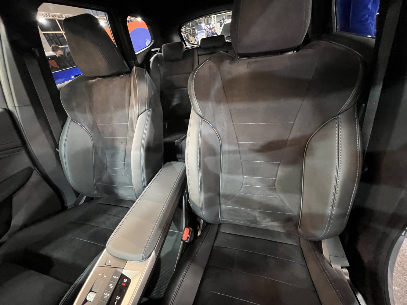 Front seats with leather and suede upholstery plus center armrest and control buttons