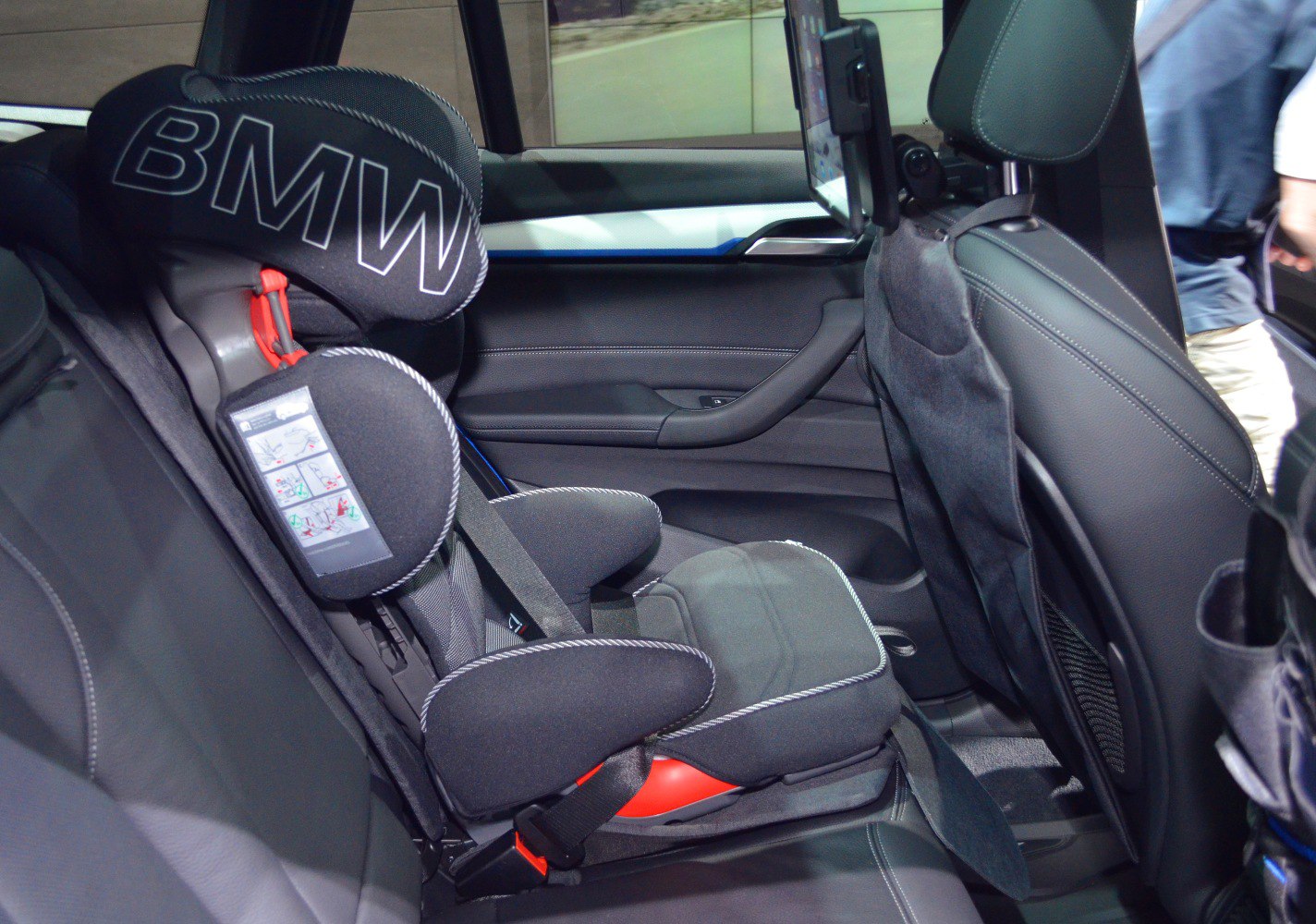 Rear seat child safety car seat with seat belt in vehicle interior