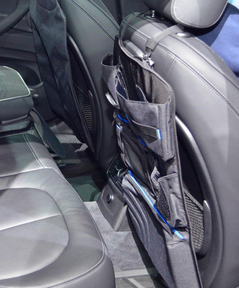 Rear seat interior storage organizer with multiple compartments on front seat back.