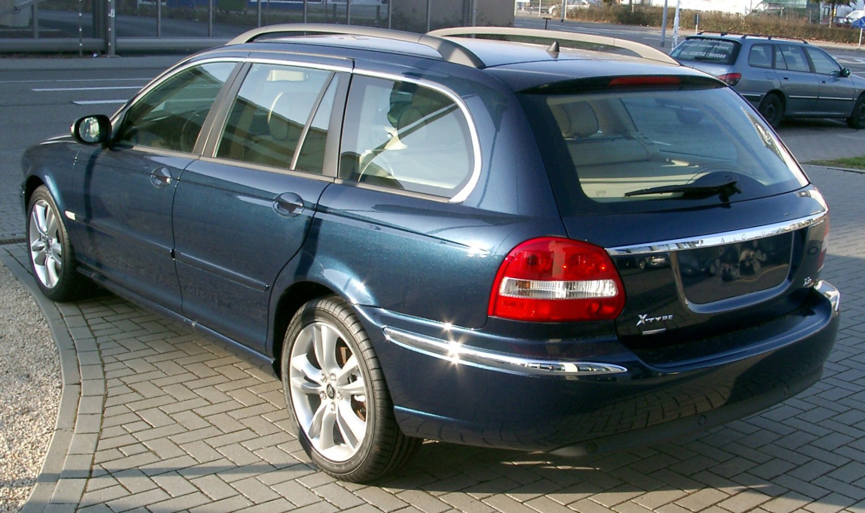 Rear and side view of an estate vehicle with chrome trim and red taillights