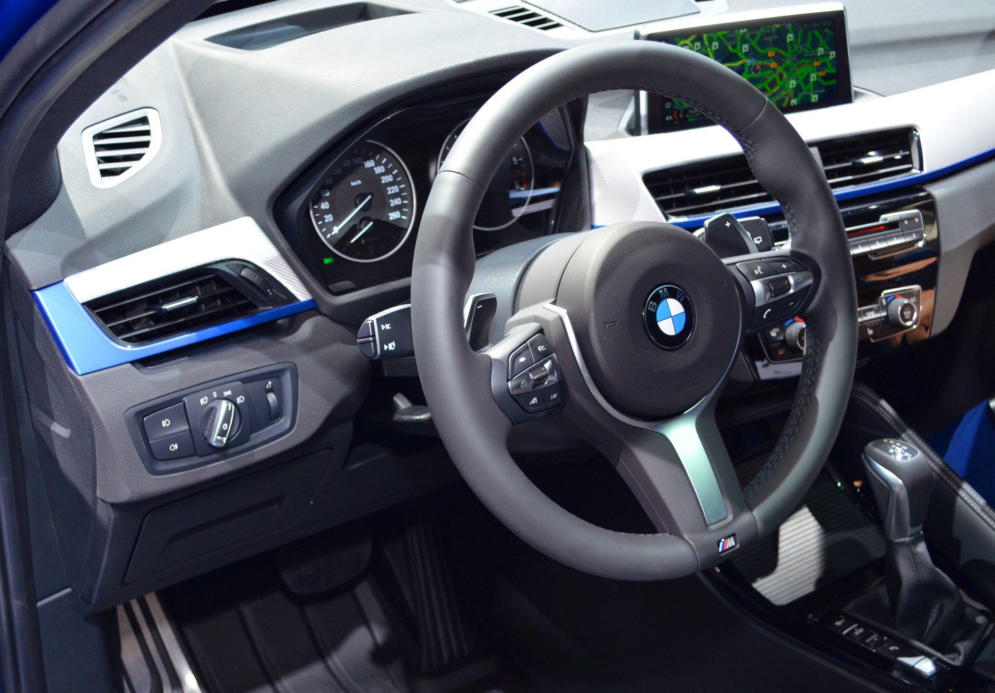 Steering wheel, dashboard, and center console with navigation screen and controls