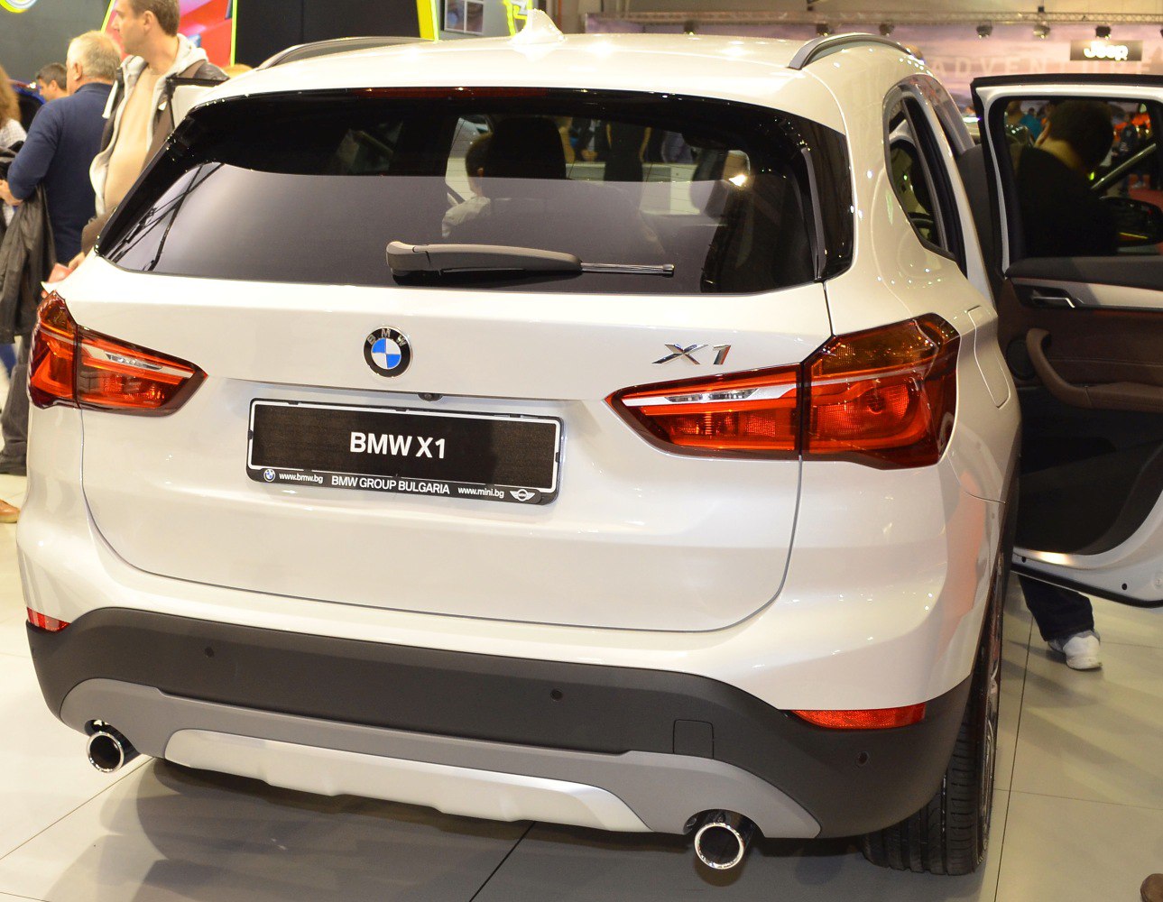 Rear view with dual exhausts and signature tail lights.