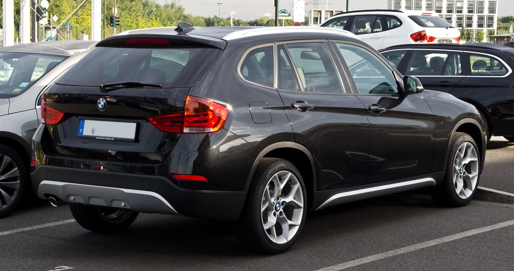 Rear and side view of a black compact SUV with alloy wheels and modern tail lights.