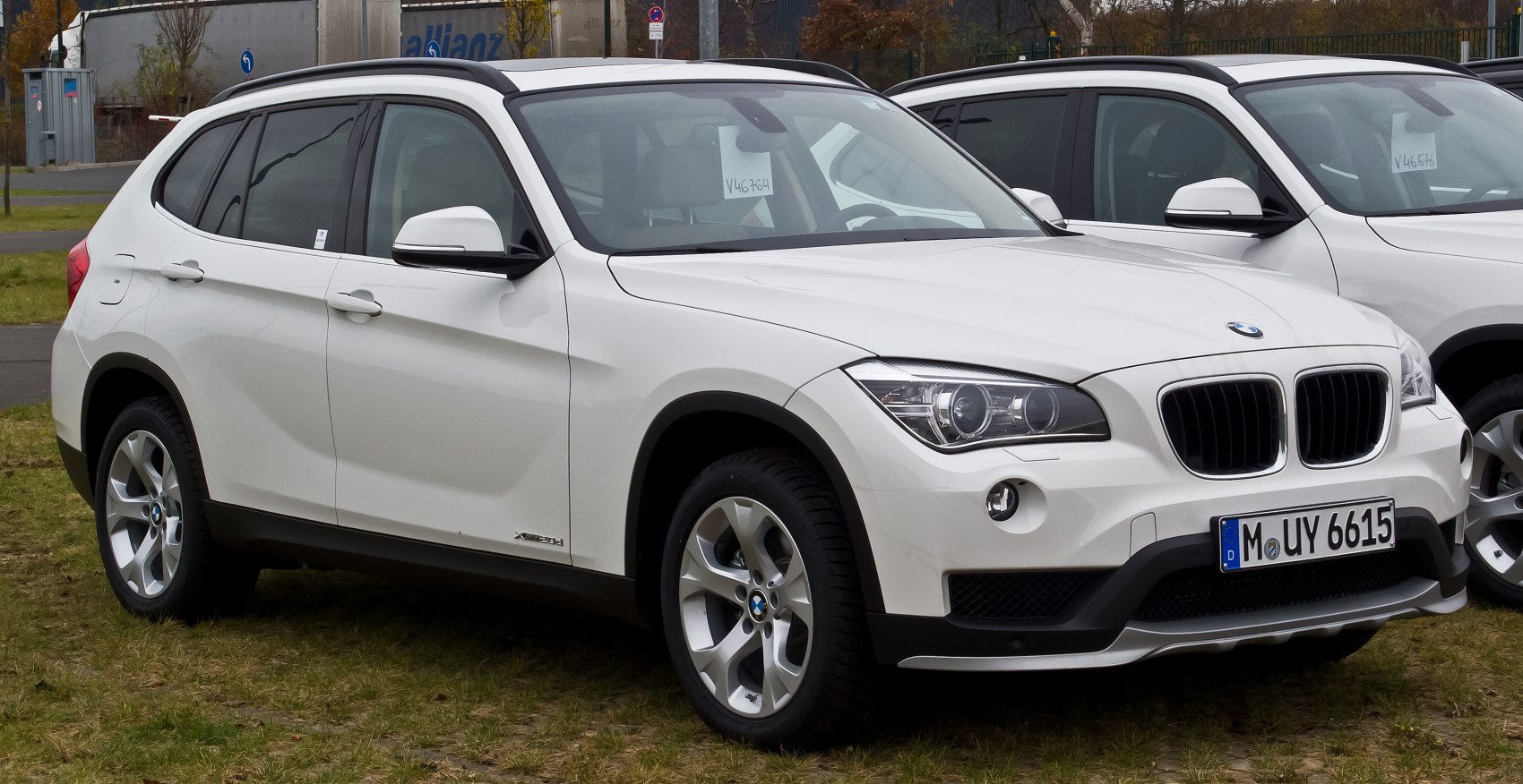 Front side view of white compact luxury SUV with iconic kidney grille and modern headlights