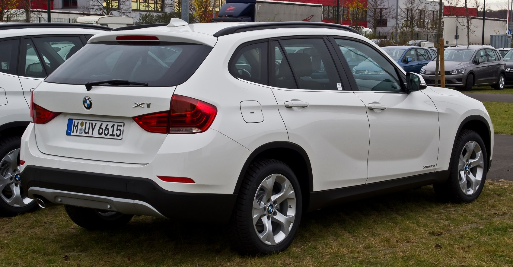 Rear side view showing roof rails, taillights, and alloy wheels.