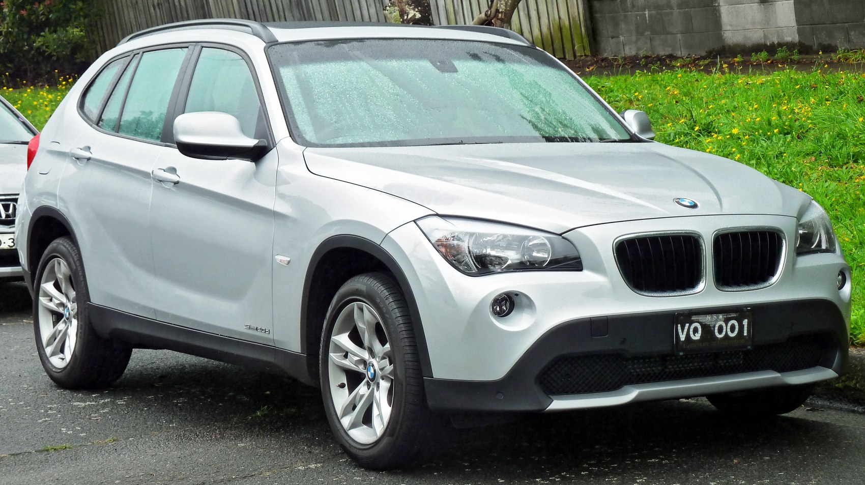 Silver SUV front side with kidney grille and plastic wheel arch trims