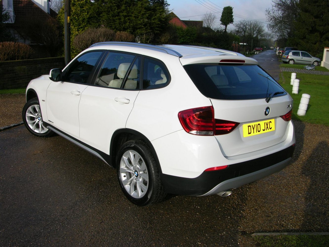 Rear side view showing taillights, alloy wheels, and roof rails.