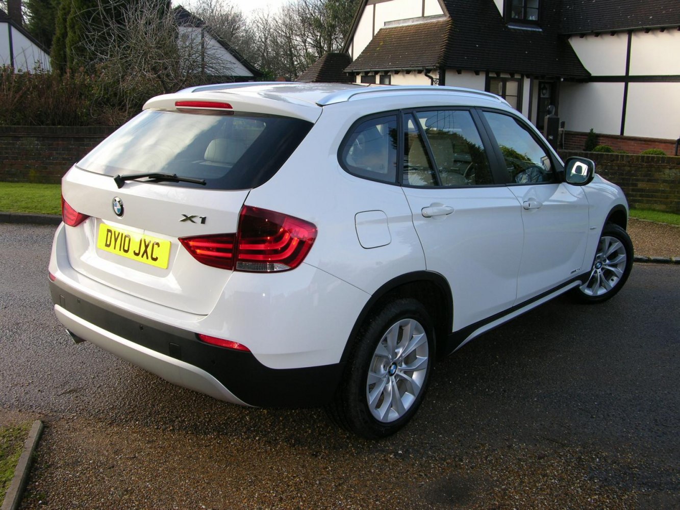 Rear and side view of white compact SUV with distinctive taillights and alloy wheels