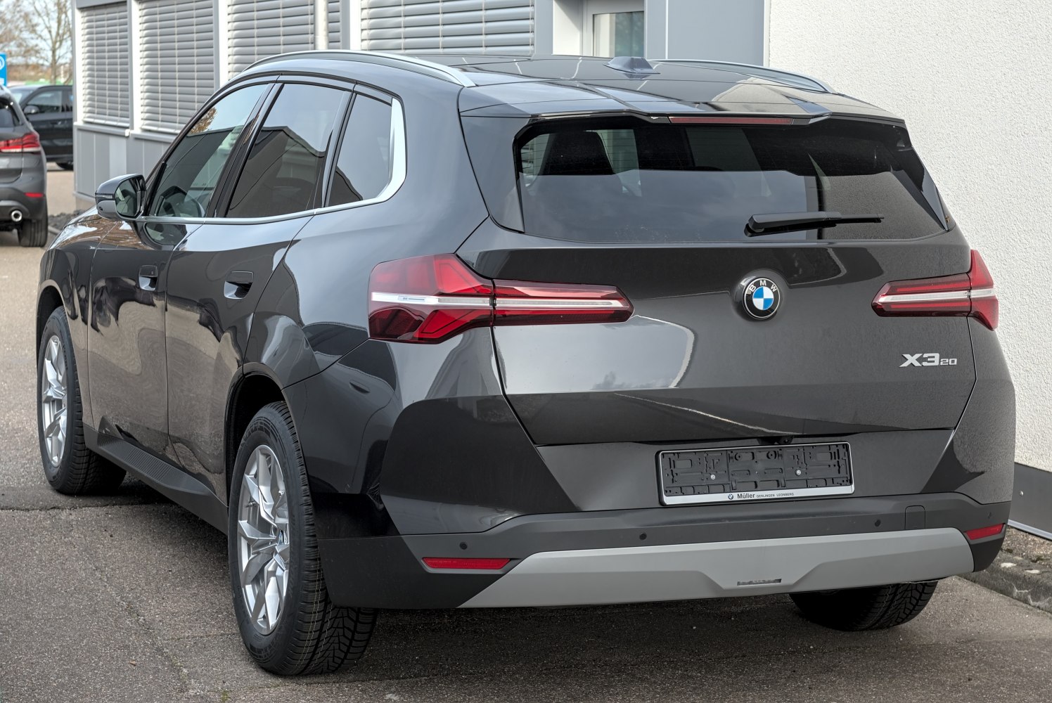 Rear view of a modern SUV with sleek horizontal taillights and tinted rear window