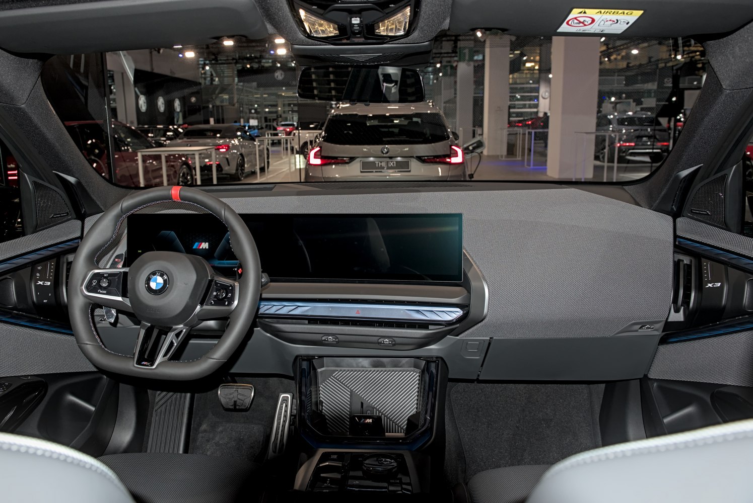 Digital dashboard and M Sport steering wheel in modern SUV interior