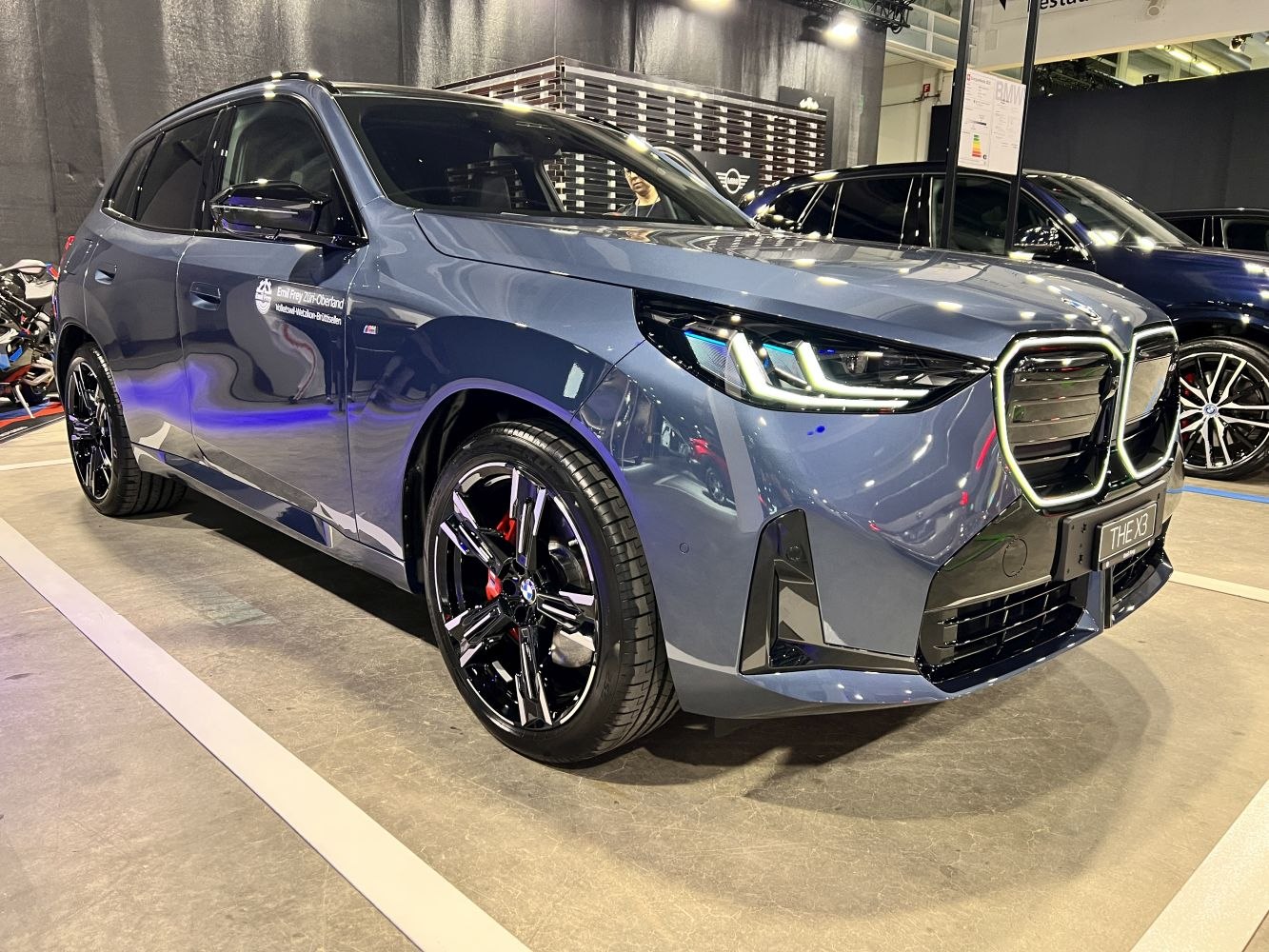 Modern electric SUV with large kidney grille and sharp LED headlights