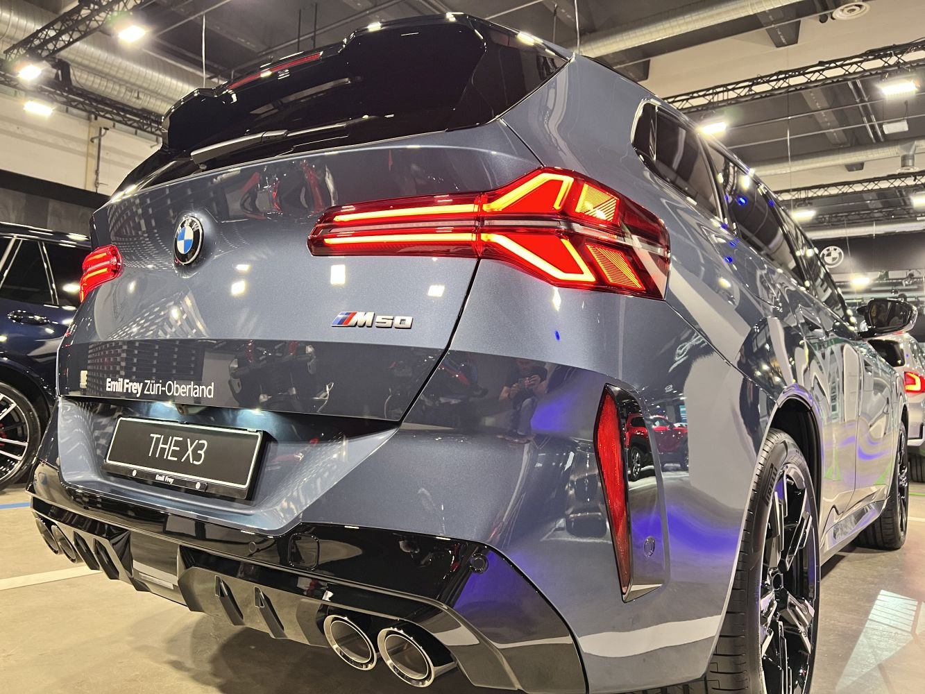 Modern sporty SUV rear with LED tail lights and quad exhaust pipes