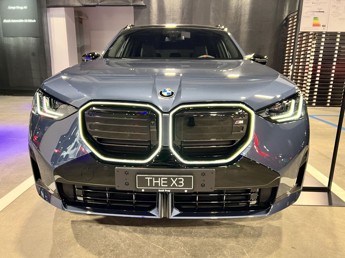 Front close-up showing illuminated kidney grille and LED headlights
