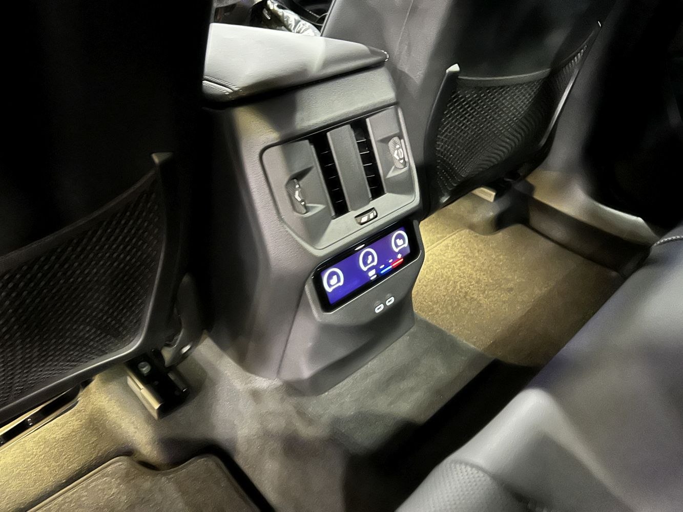 Rear seat climate control panel with air vents and digital touch screen