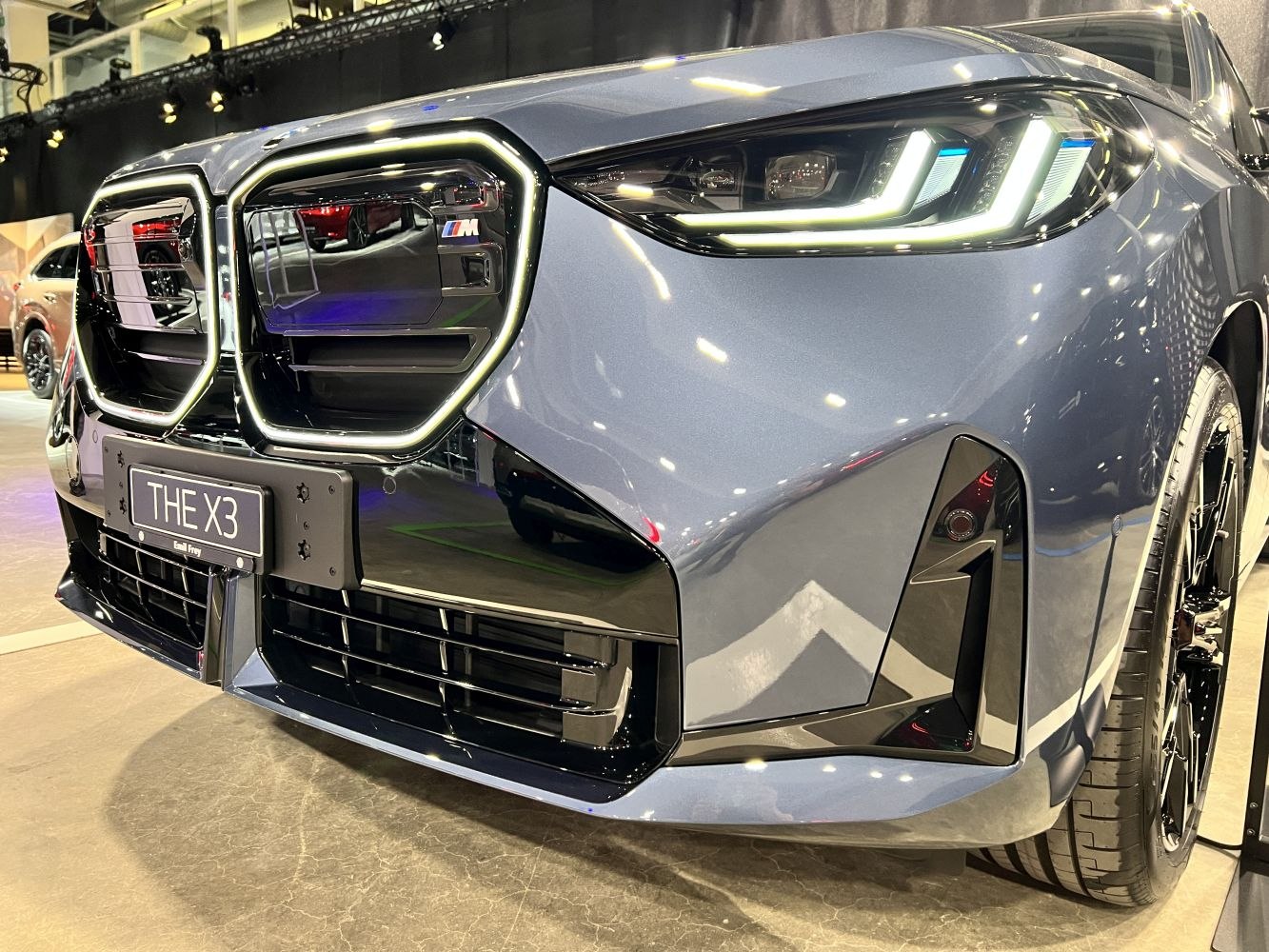 Close-up of distinctive dual grille and angular LED headlights with modern design