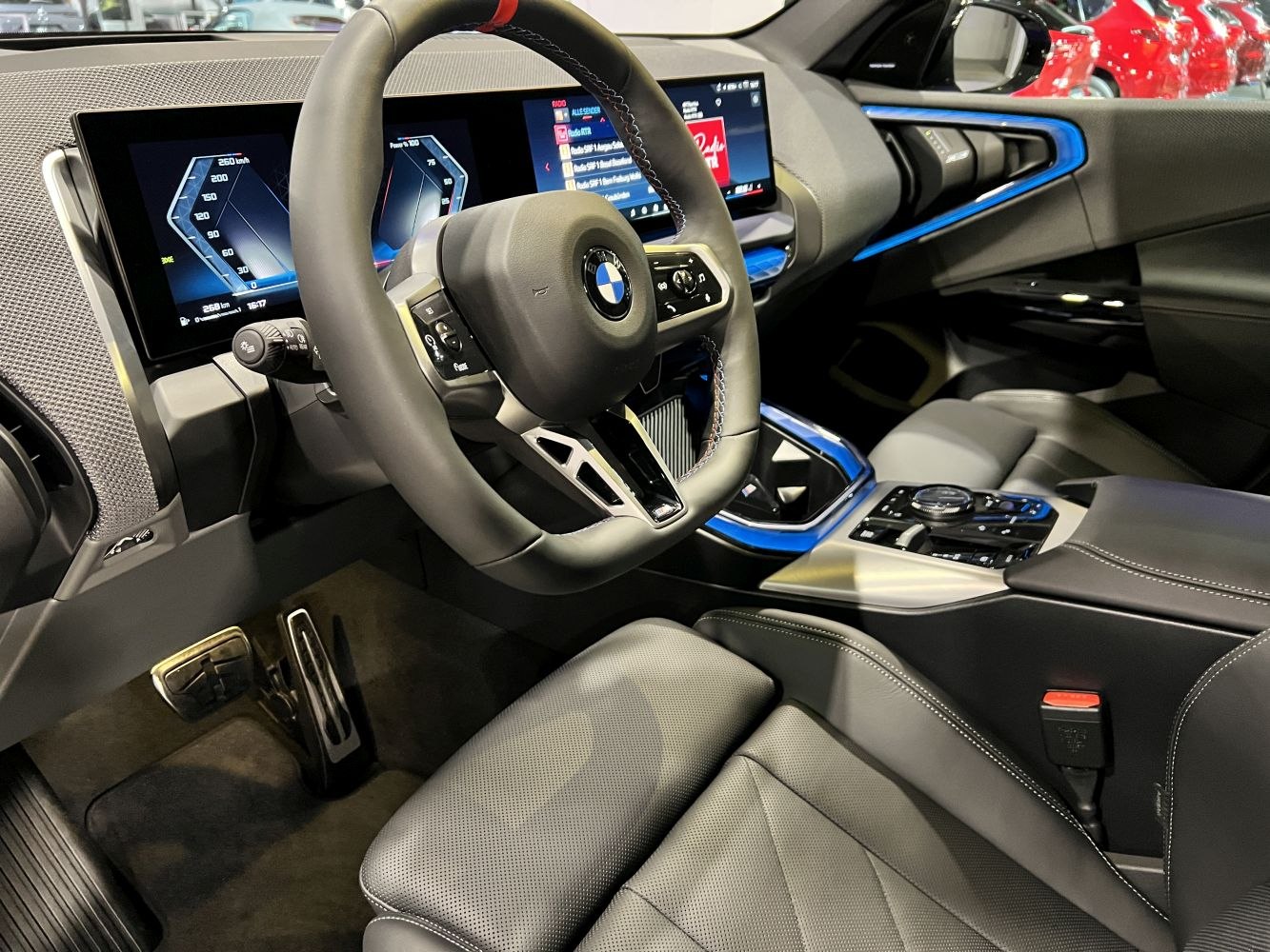 Digital instrument cluster and blue accent interior trim with sporty steering wheel