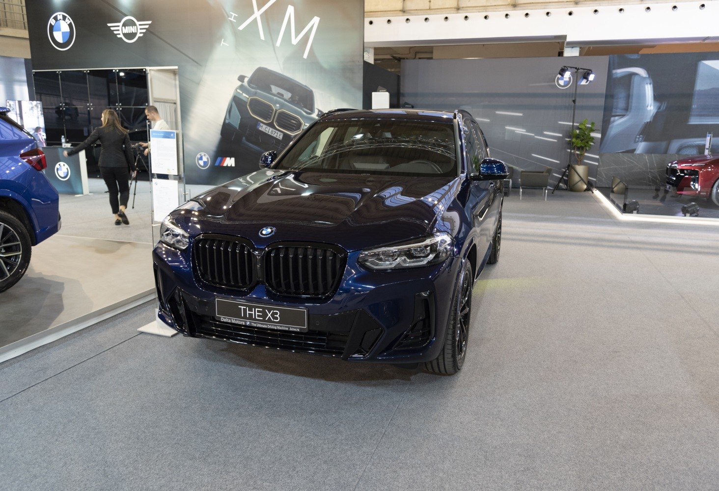 Front view of blue SUV with BMW kidney grille and LED headlights