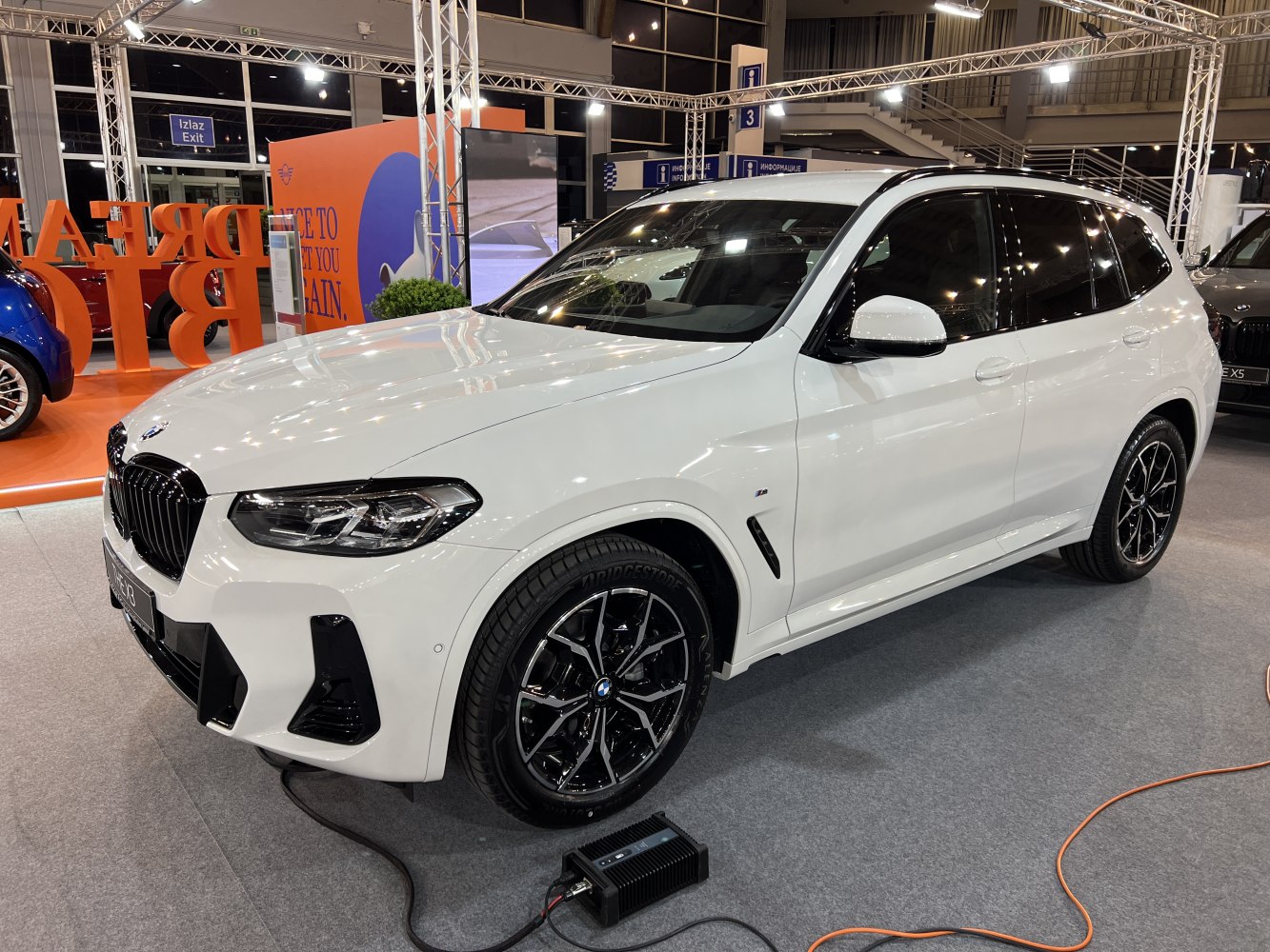 Front side view of white SUV with alloy wheels and modern sleek design