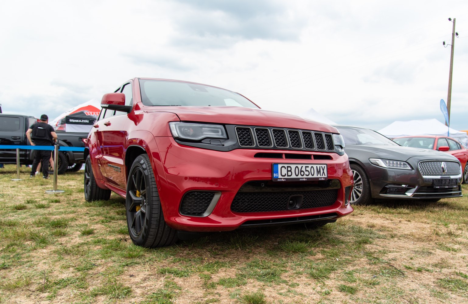 Red SUV with seven-slot front grille and LED headlights