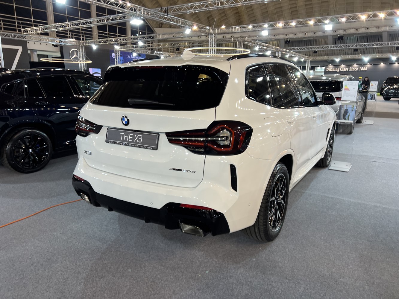 Sporty rear lights and dual exhausts on a white SUV rear