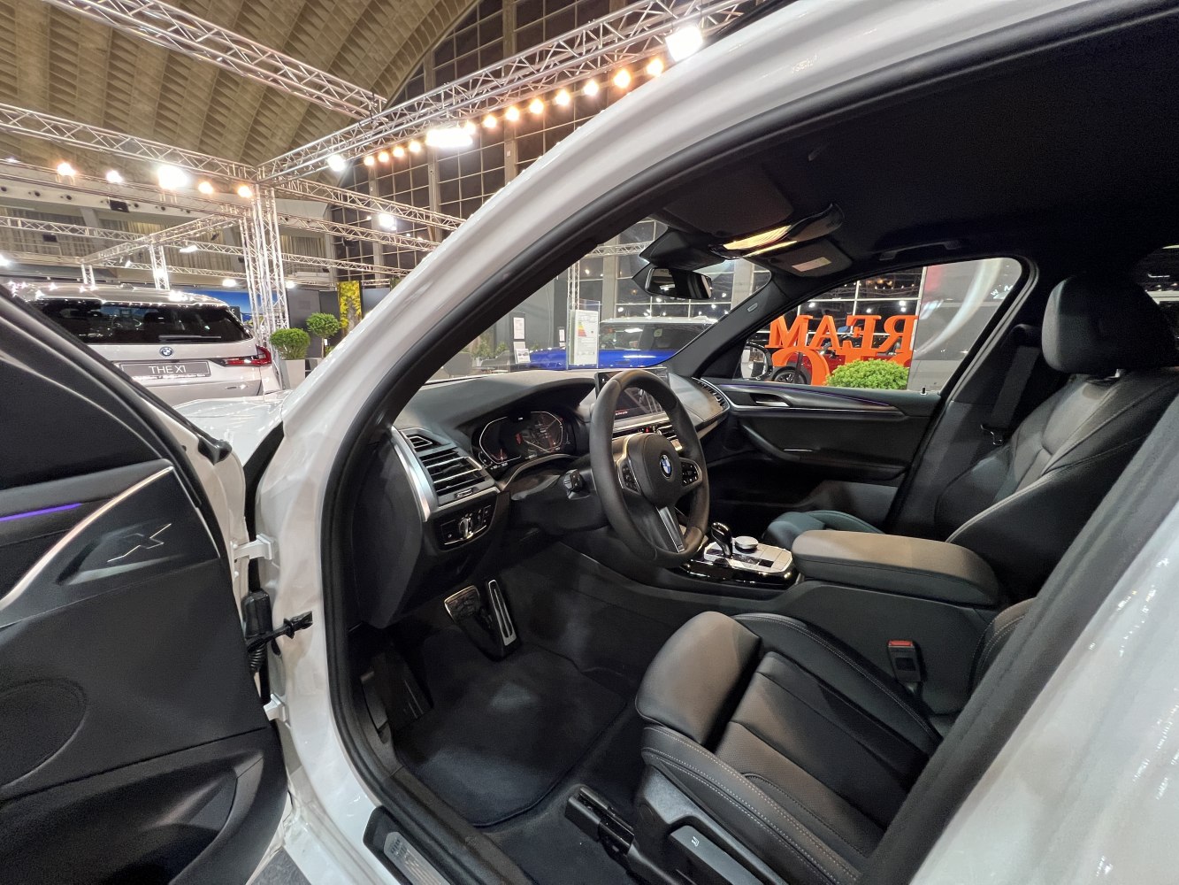 Luxury car interior with black leather seats and advanced dashboard