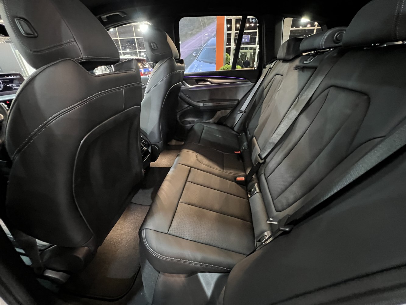 Spacious black leather rear seating with headrests and seat belts