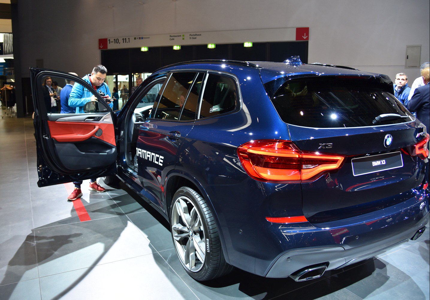 Rear view with open driver door and visible performance badge