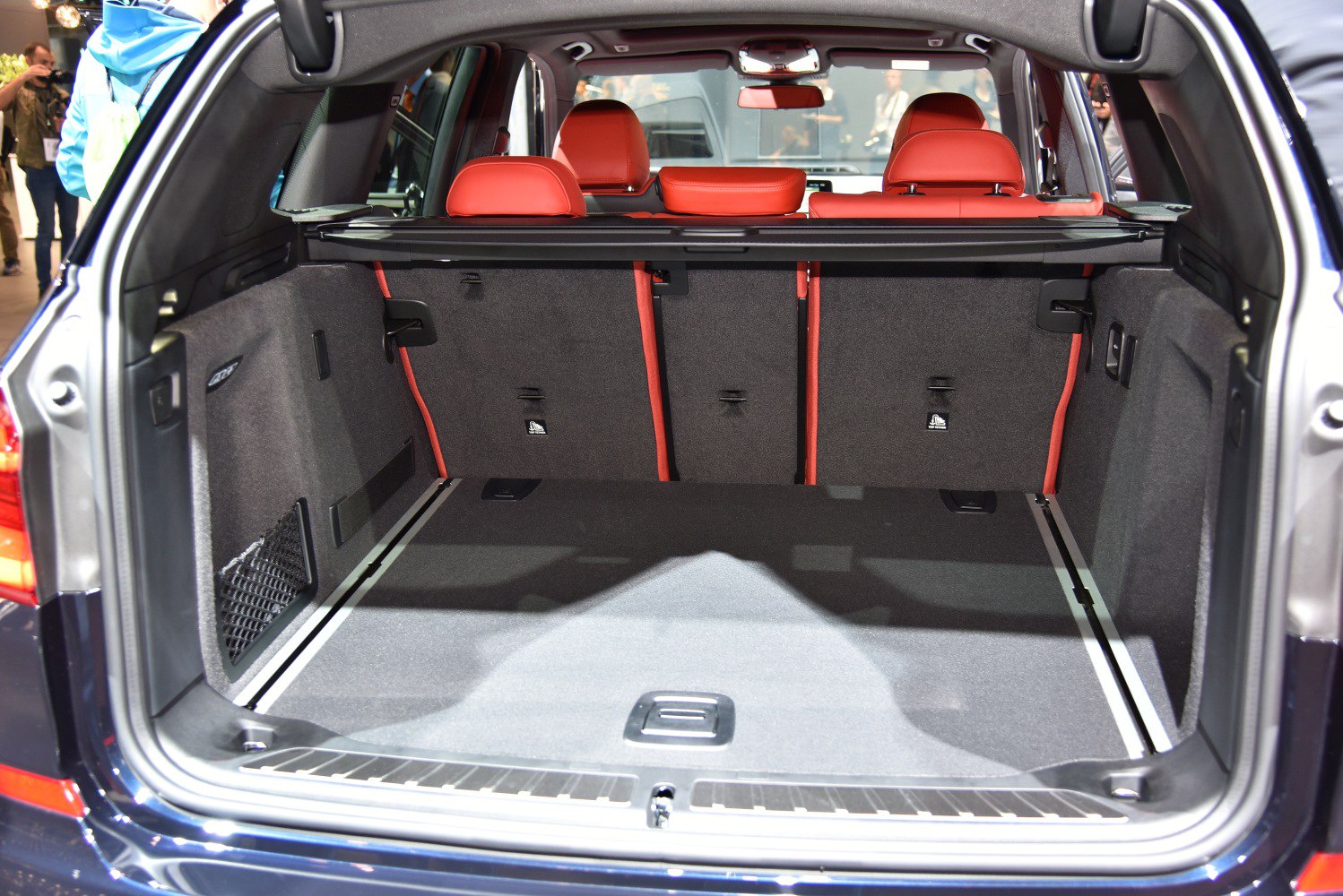Rear cargo area with red interior seats and foldable rear seatbacks