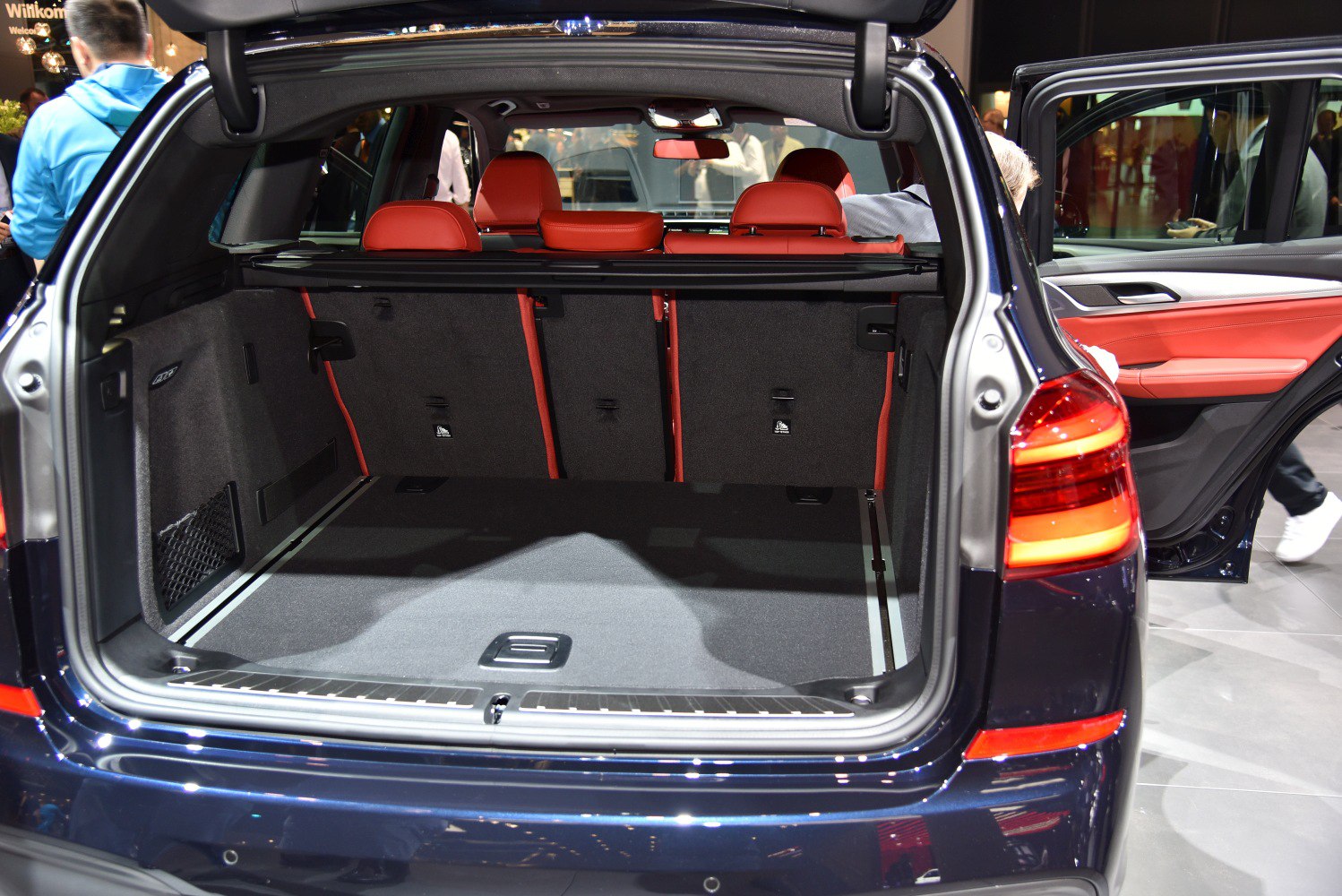 Spacious SUV cargo area with red interior seats and open rear door