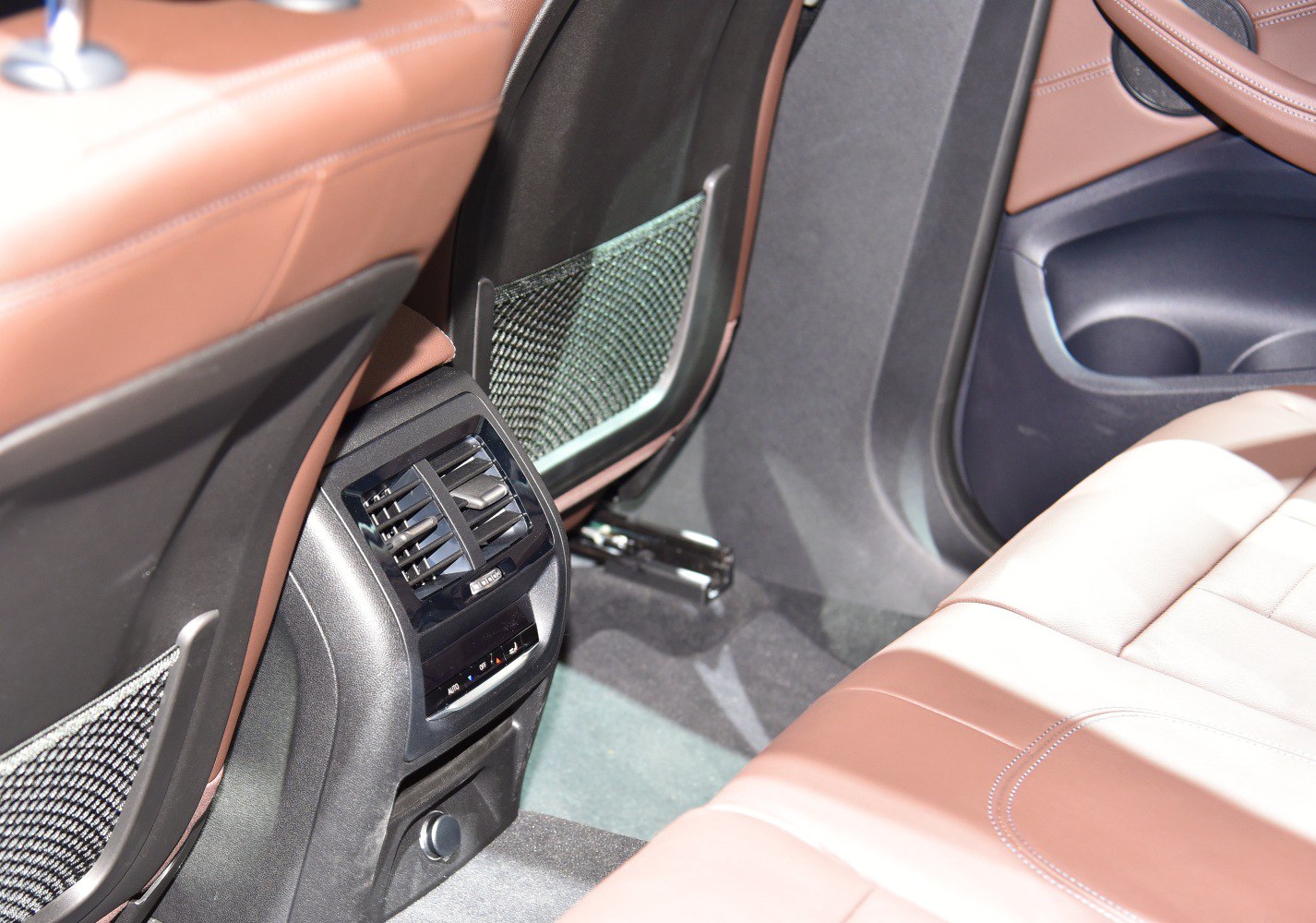 Rear passenger air vents and brown leather seating