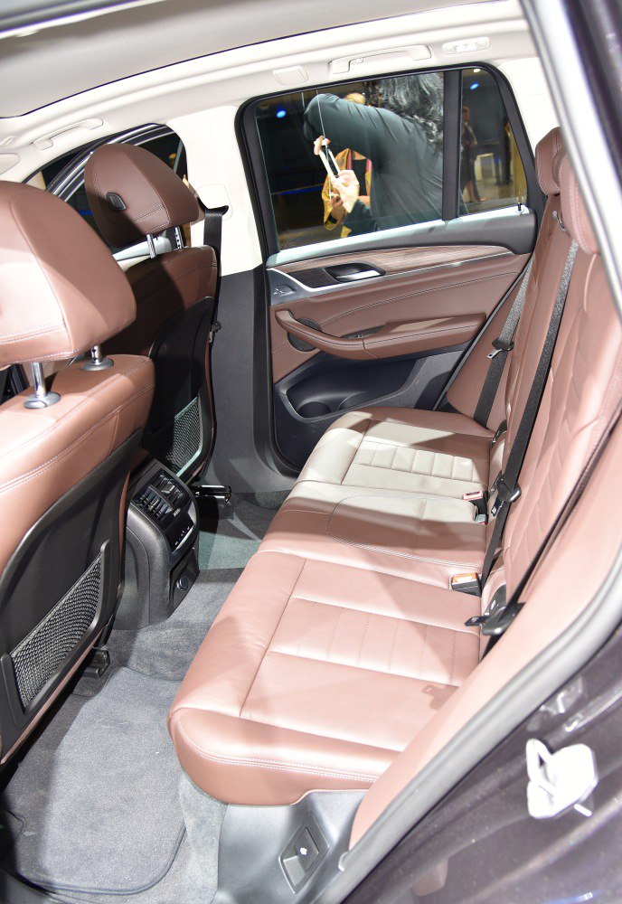 Spacious rear seating with brown leather upholstery and rear air vents