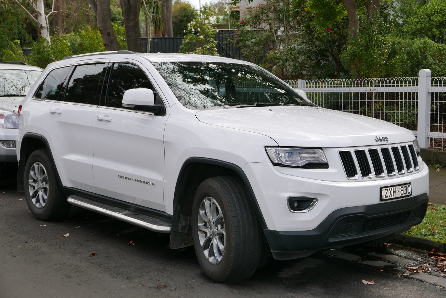 Front-side view of white SUV with signature grille and headlight design