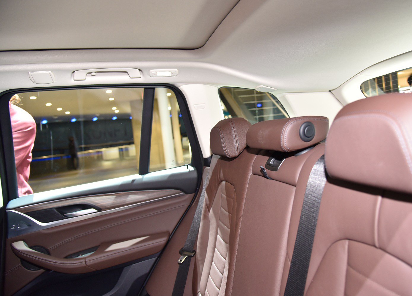 Brown leather rear seats and door panel with seat belt
