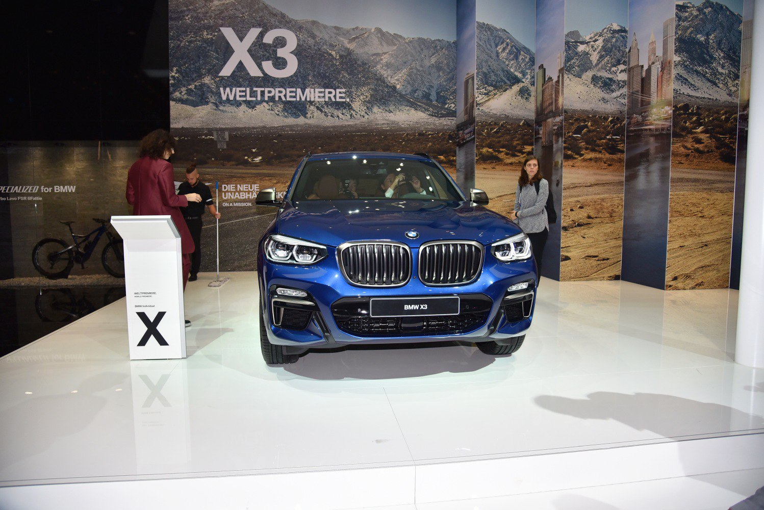 Front view of blue luxury SUV with distinctive grille and LED headlights