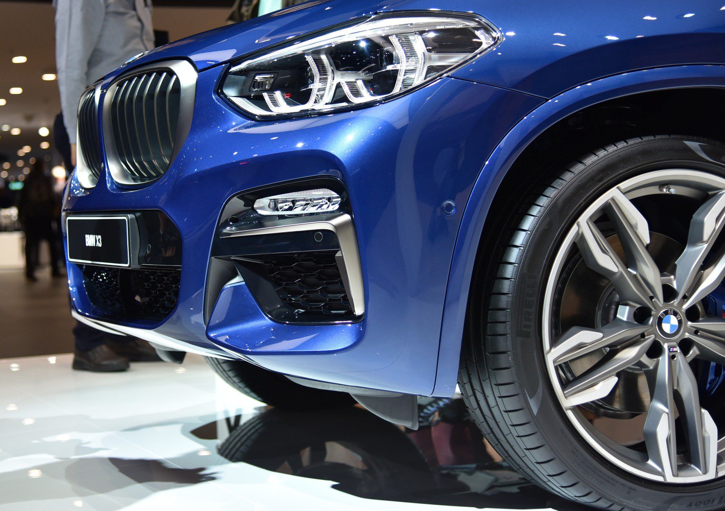 Close-up of front headlight and alloy wheel of a modern SUV