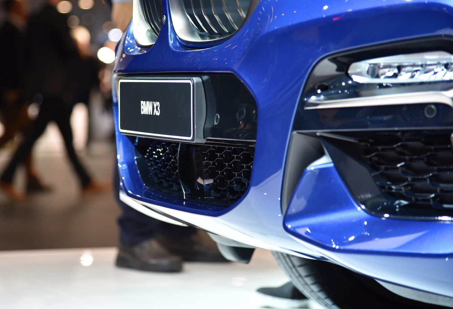 Close-up of front grille and headlight on blue SUV