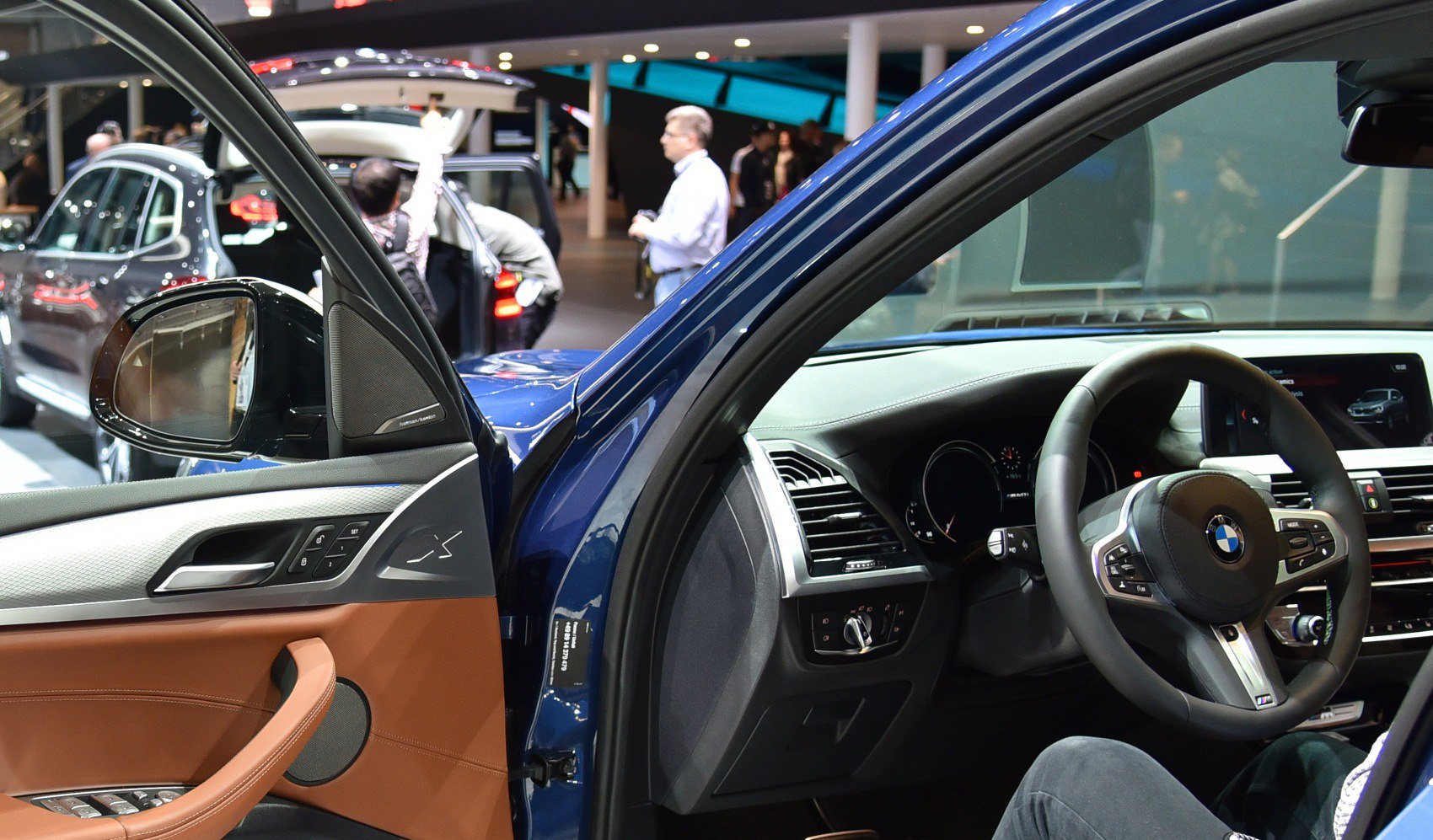Driver's side door and steering wheel of a modern luxury SUV interior