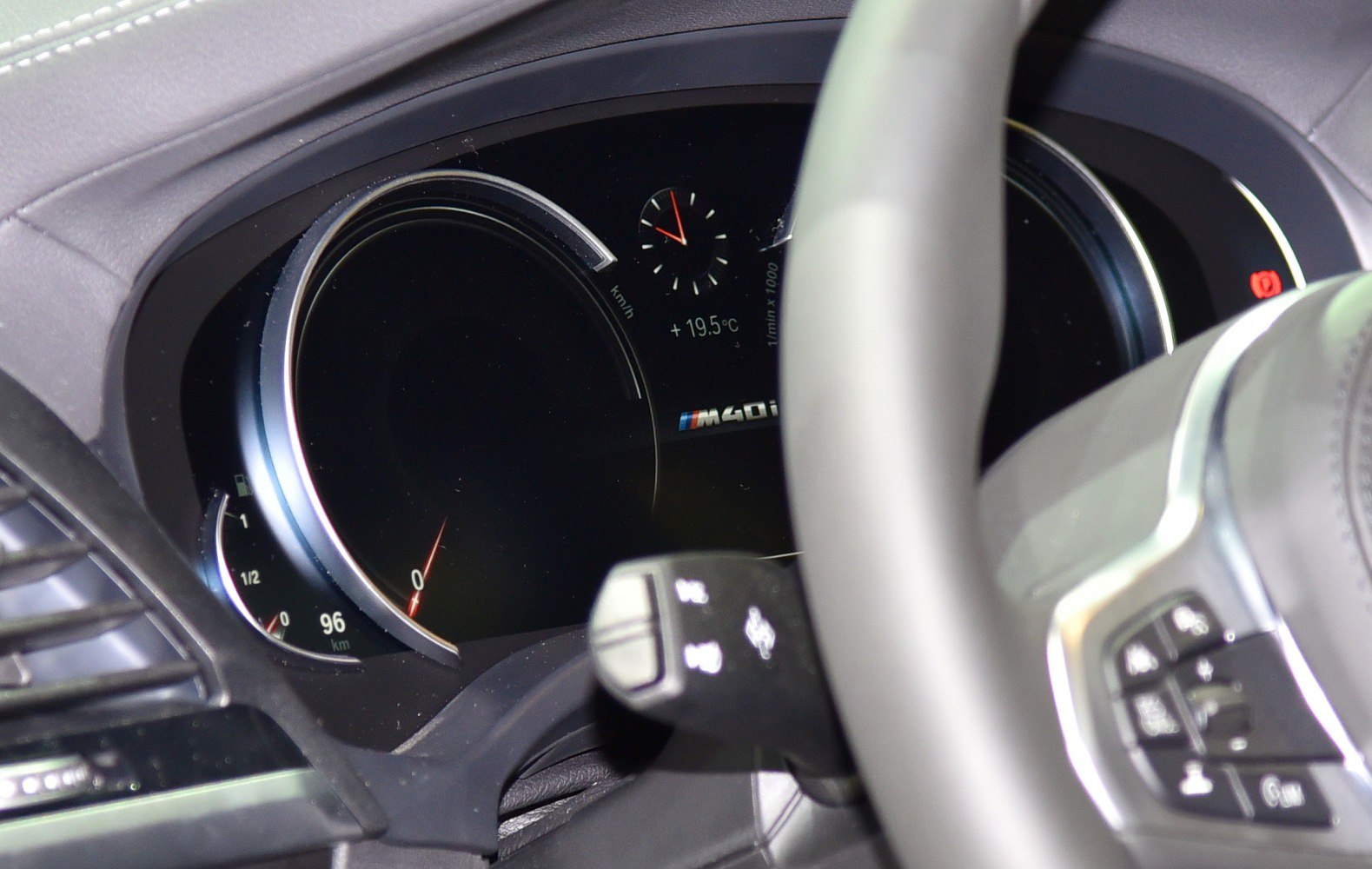 Digital instrument cluster and steering controls in modern car dashboard