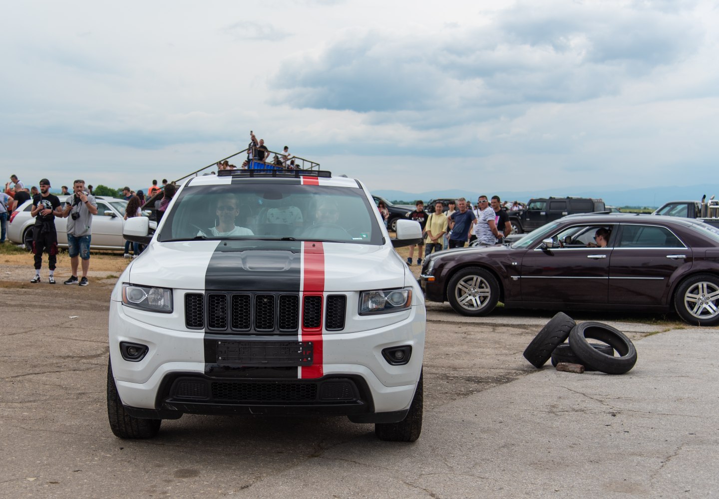 Front view of SUV with black and red racing stripes